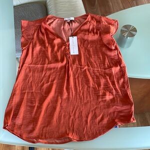 Women’s small cap sleeve silky shirt. 100% polyester.  NWT. Fits like a Medium